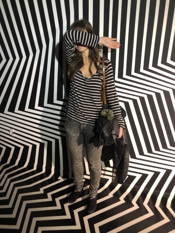 me standing in front of a black and white striped art instillation, while also dressed in black and white stripes